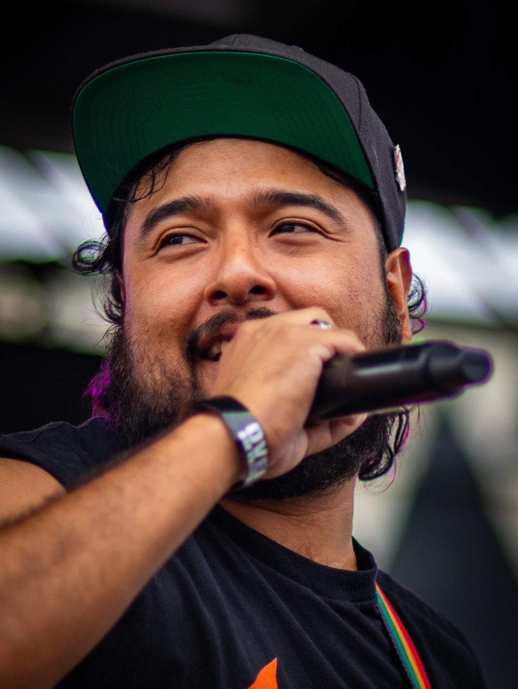 Singer smiling while holding a microphone